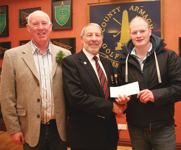 County Armagh Golf Club Captain John Flack presents Gerard O'Callaghan with his prize after winning the St Patrick's Day Open Stableford Competition. Included (left) is runner up Derek McKeever.